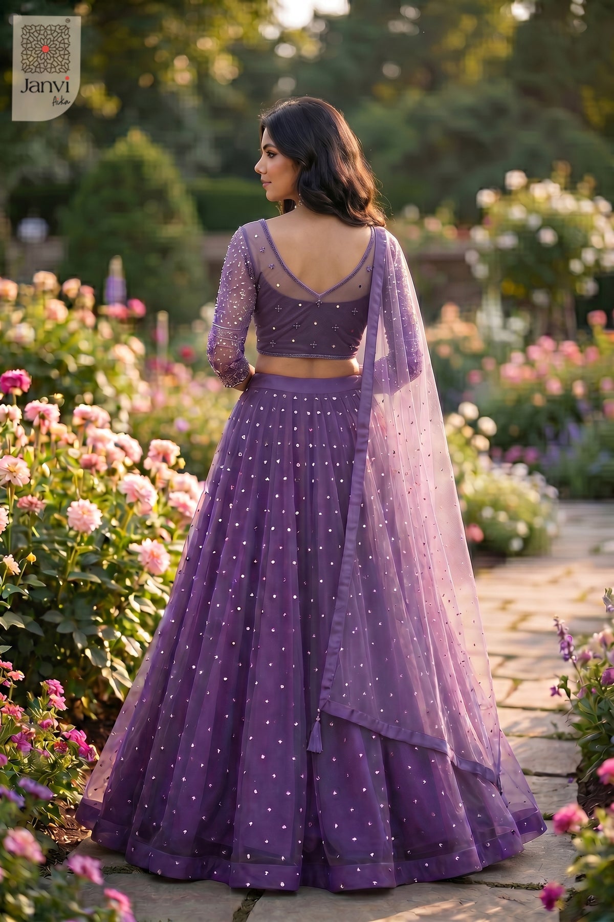 This rear full standing shot showcases a gorgeous purple net heavy bridal lehenga.