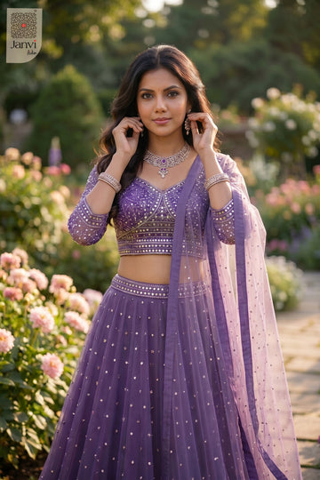 Waist up front smiling view of a classic purple net choli outfit design for upcoming festivals.