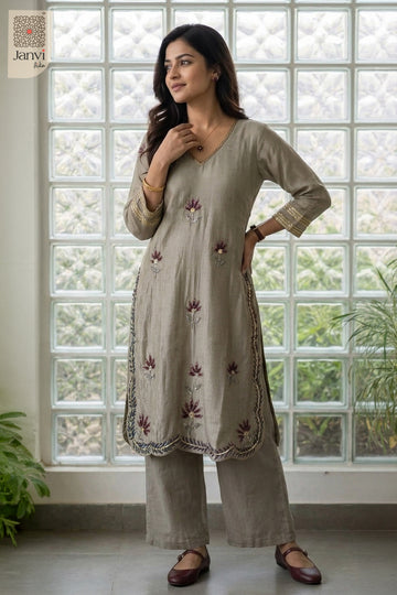 Standing side pose with hand on hip in an elegant grayish blue party wear churidar.