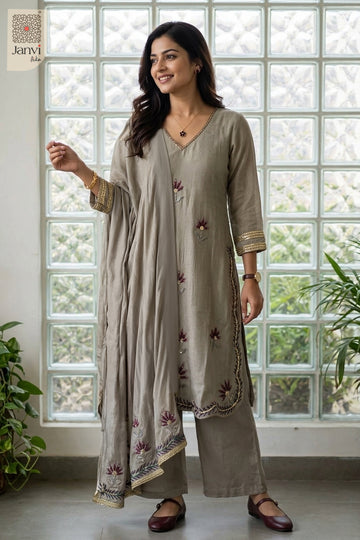 Front standing shot displaying side tie tassels on grayish blue churidar set readymade.
