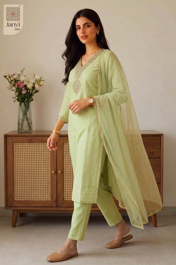 Front standing studio portrait wearing a pastel green tailored churidar set readymade.