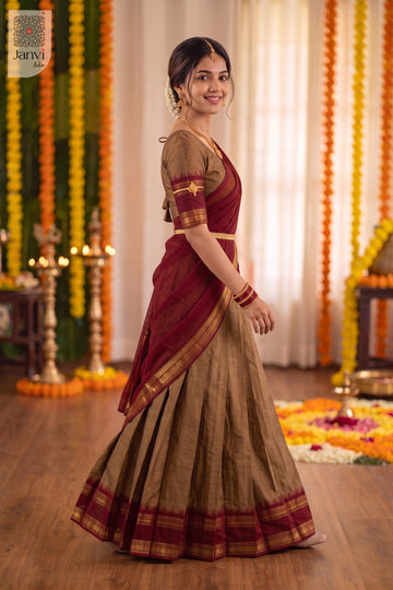 Side profile walking view of a bronze and maroon traditional lehenga saree flare.