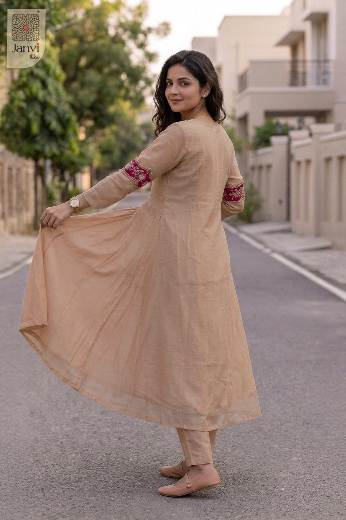 Rear view of a light peach flared anarkali kurta with sheer scalloped dupatta.