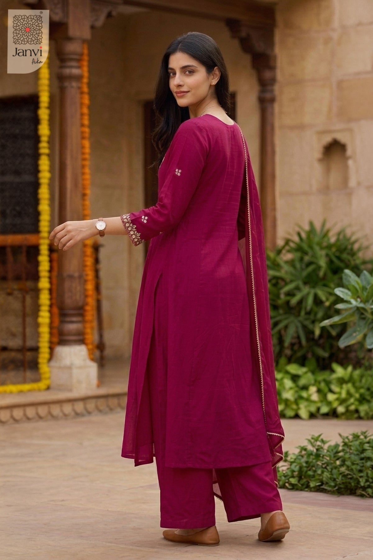 Rear full length view of a rani pink festive anarkali kurta with sheer dupatta drape.