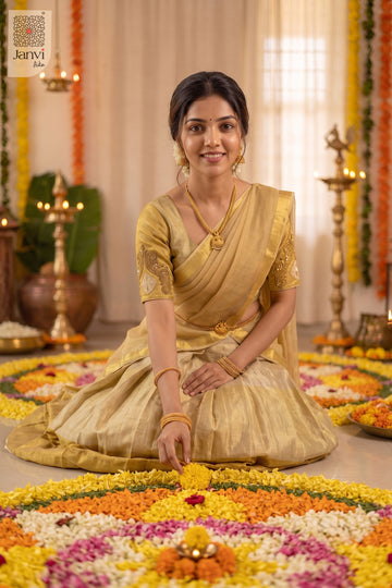 Model sitting making flower rangoli in a radiant golden women lehenga saree attire.